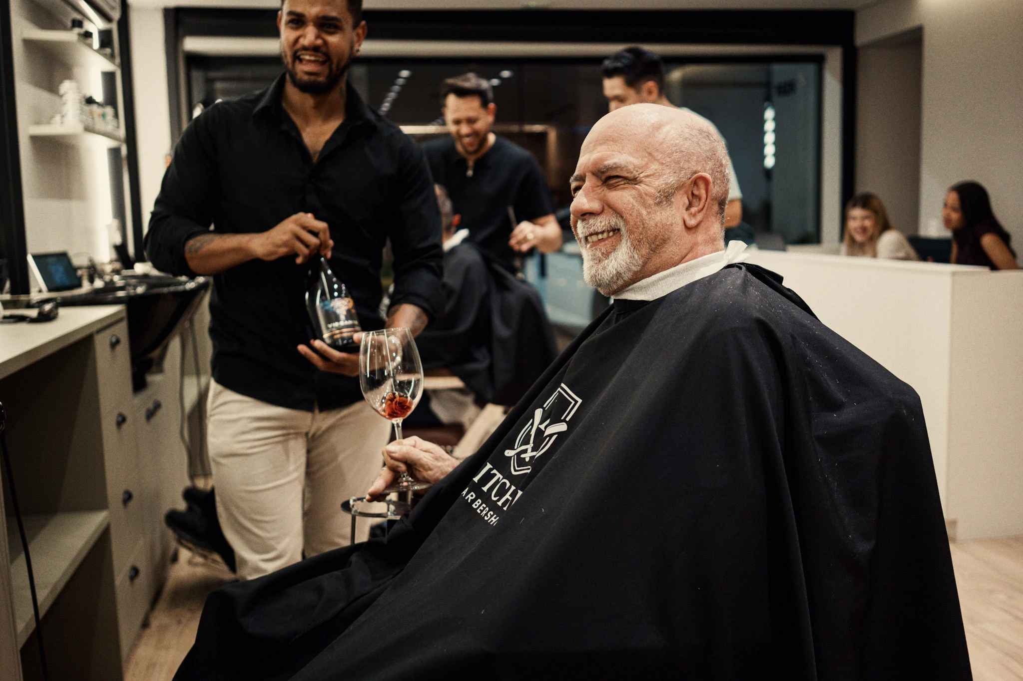 Cliente vivendo a experiência Mitchel com vinho durante o atendimento